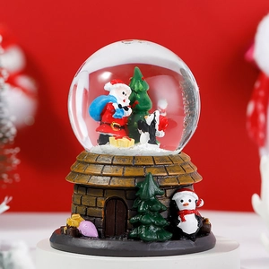 Close-up of Santa Claus inside a Christmas crystal ball with a vintage stone house base