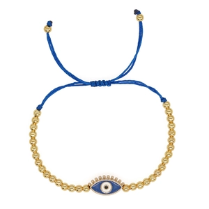 Detail of blue woven evil eye bracelet with 4mm gold beads and adjustable cord