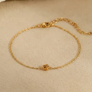 Detail of minimalist gold rose flower pendant bracelet with adjustable chain measurements