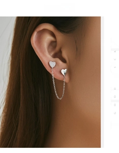 Detail of s925 silver asymmetrical heart drop earrings with zircon paving and long chain