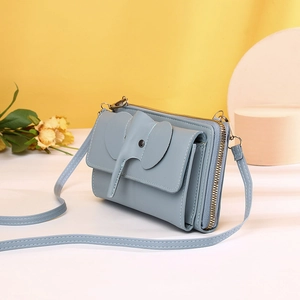 Detail view of the multi-layer structure and elephant flap on the blue crossbody phone bag