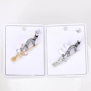 Detail of flying cat on broom brooches with sparkling crystals in gold and silver finish