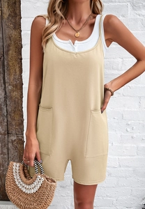 Detail of khaki jumpsuits with functional front pockets and thin shoulder straps for women