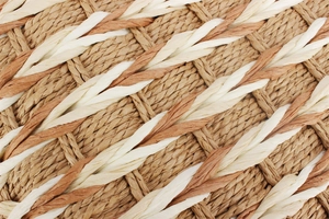 Macro detail of the woven textured straw material in natural, coffee, and ivory tones