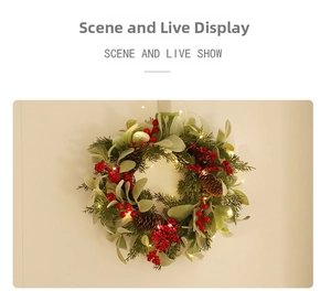 Close-up of Christmas wreath with pine cones, red berries and warm LED lights