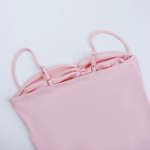 Detailed close-up of pink ribbed fabric showing elegant neckline and shoulder strap stitching