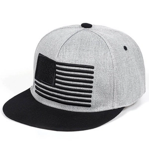 Detailed close-up of American flag embroidery on a grey and black flat brim hip hop hat