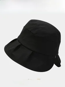 Close-up of black bucket hat with textured fabric and stylish pleated brim details