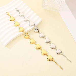Détails des bracelets en forme de cœur en or 18 carats et argent sur fond texturé