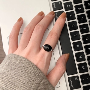 Detail of 925 silver black agate oval gemstone ring worn during office work at computer