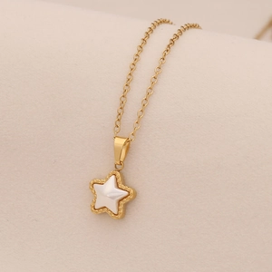 Elegant gold stainless steel necklace with a white shell star pendant on a beige surface