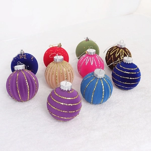Detailed view of colorful flocked Christmas ornaments with gold glitter stripes and dots