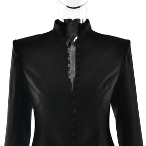 Detail of elegant black blazer dress featuring a stand collar and deep V-neckline buttons