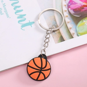 Close-up of a realistic orange basketball keychain made of durable PVC material