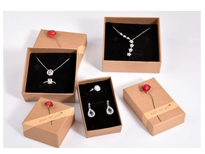 Brown kraft paper jewelry boxes with red paper flowers for rings and necklaces