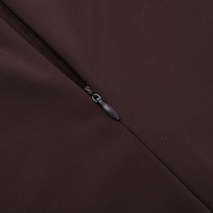 Close-up of the high-quality invisible zipper on dark brown athletic fabric jumpsuit