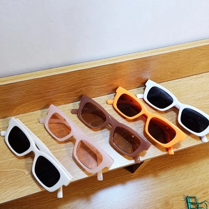 Rectangle fashion sunglasses displayed in white, pink, brown, and orange colors