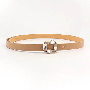 Detailed macro of a slim camel PU leather belt featuring a square rhinestone buckle