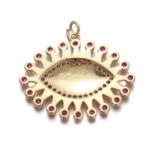 Golden sunburst evil eye pendant necklace with vibrant red zircon stones on white background