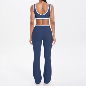 Rear view of navy blue yoga set with contrast piping on sports bra and flared pants