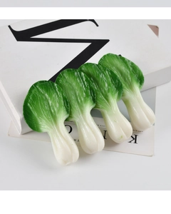 Detailed view of four realistic PVC green vegetable leaves on a white background prop