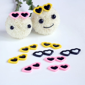 DIY heart-shaped resin sunglasses accessories in pink, yellow, and black colors