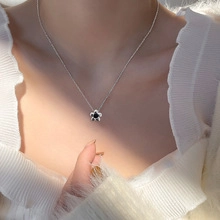 Elegant silver-toned lily of the valley flower pendant necklace jewelry on female model
