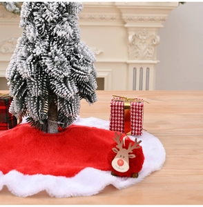 Close-up of mini red plush Christmas tree skirt with white faux fur wavy edge trim