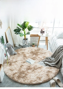 Detail of round light coffee plush rug with soft long fur texture in a cozy bedroom setting