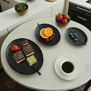 Set of 3 vintage black leaf-shaped decorative serving trays with detailed vein textures