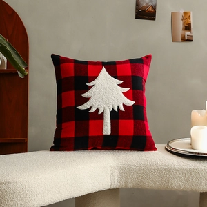 Christmas red and black plaid pillow cover with white tree embroidery on soft white bench