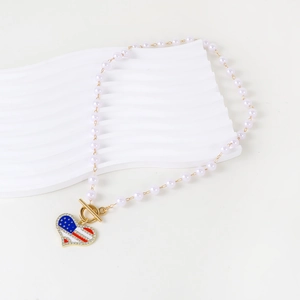 Elegant pearl necklace with American flag heart pendant and gold T-bar toggle clasp