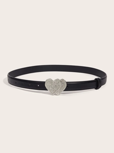 Close-up of black leather belt featuring a silver heart buckle with sparkling rhinestones