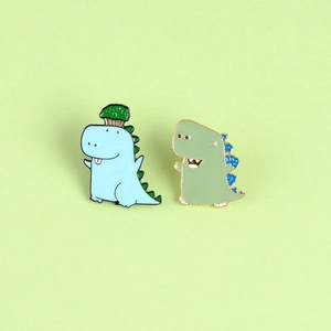 Cute cartoon dinosaur enamel pins set in pastel blue and green for clothes decoration