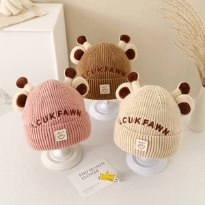 Cozy winter knitted hats for babies with cute 3D antlers and soft embroidery detail