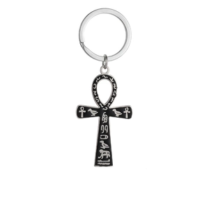 Macro detail of black Ankh key chain with silver Egyptian hieroglyphic symbols engraving