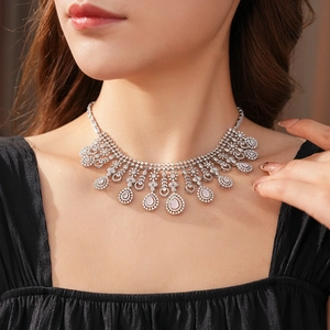 Exquisite necklace with pink and clear zircons shown on model for formal dinner styling