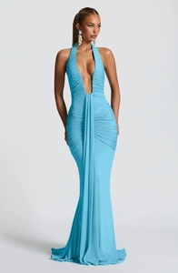 Detail of elegant sky blue halter neck dress featuring a deep V-neck and ruched textures