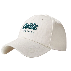 Detail of cream baseball cap featuring dark green 'Create NEW LIFE' embroidery texture