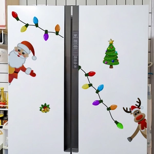 Close-up of reflective Christmas gnome and reindeer magnets on a white refrigerator door