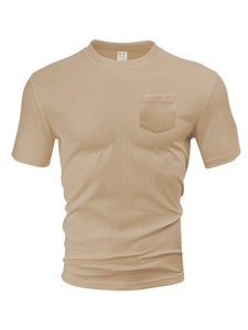 Detail of waffle knit fabric texture and chest pocket on beige men's t-shirt