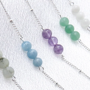 Detail showing five assorted natural stone bead bracelets on 925 silver plated chains