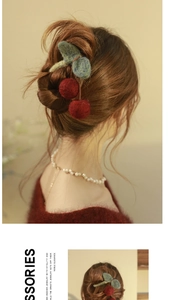 Detailed view of red knitted cherry hair claw clip on model with elegant pearl necklace