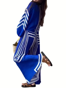 Detail of blue pleated long-sleeve top and wide-leg pants with white geometric patterns