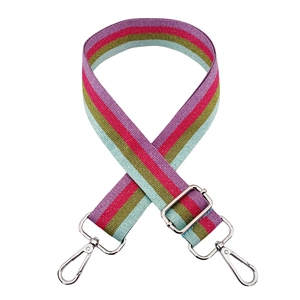 Close-up of adjustable striped bag strap with silver metal swivel hooks and buckles
