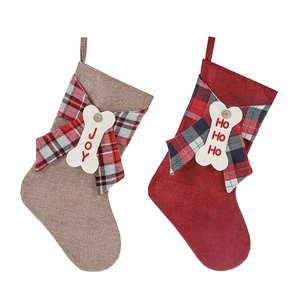 Linen Christmas stocking gift bags with bone tags and plaid bows for holiday decor