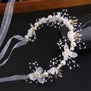 Elegant gold leaf headband with white pearls and floral petals for wedding bridal hair