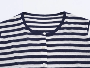 Close-up of blue and white striped knit cardigan showing round neck and white buttons