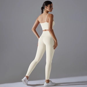Women's cream white yoga set with high-waist leggings and supportive sports tank top