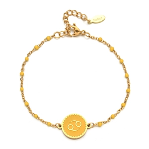 Detail of gold stainless steel beaded bracelet featuring a yellow Cancer zodiac charm